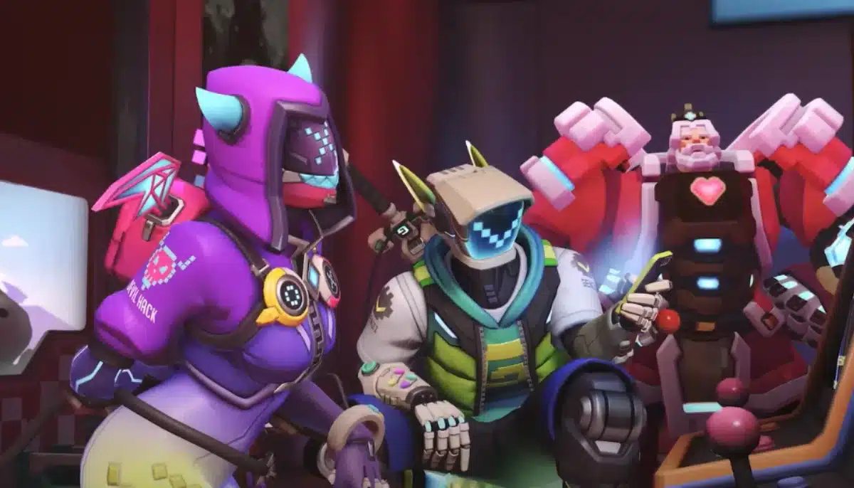 Tre färgglada Overwatch-karaktärer i futuristiska dräkter spelar arkadspel tillsammans.