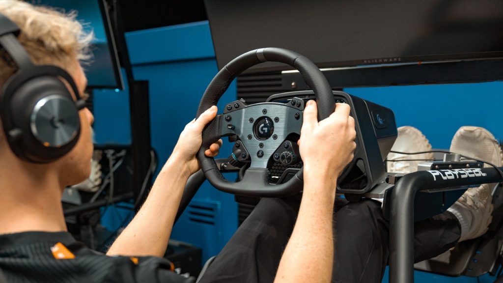 Image of McLaren Racing representative using Logitech G sim racing wheel