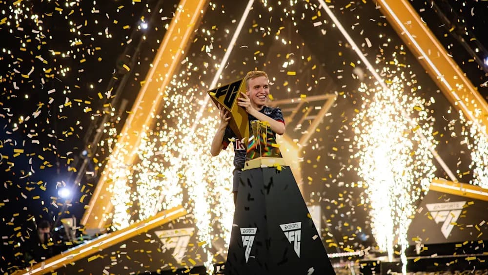 A victorious esports player holds a trophy amidst a shower of confetti and bright sparks on stage, celebrating a remarkable win.