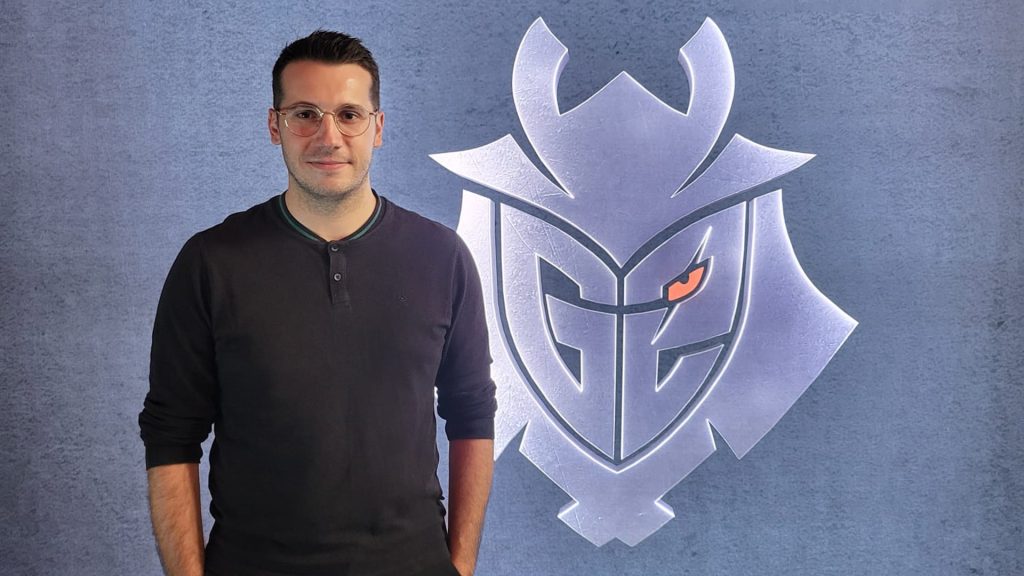 Image of Mathieu Lacrouts standing in front of wall with G2 Esports logo on