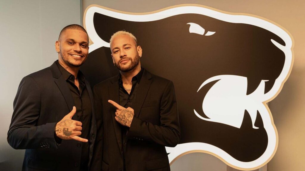 Image of Neymar Jr and Cris Guedes posing in front of FURIA logo