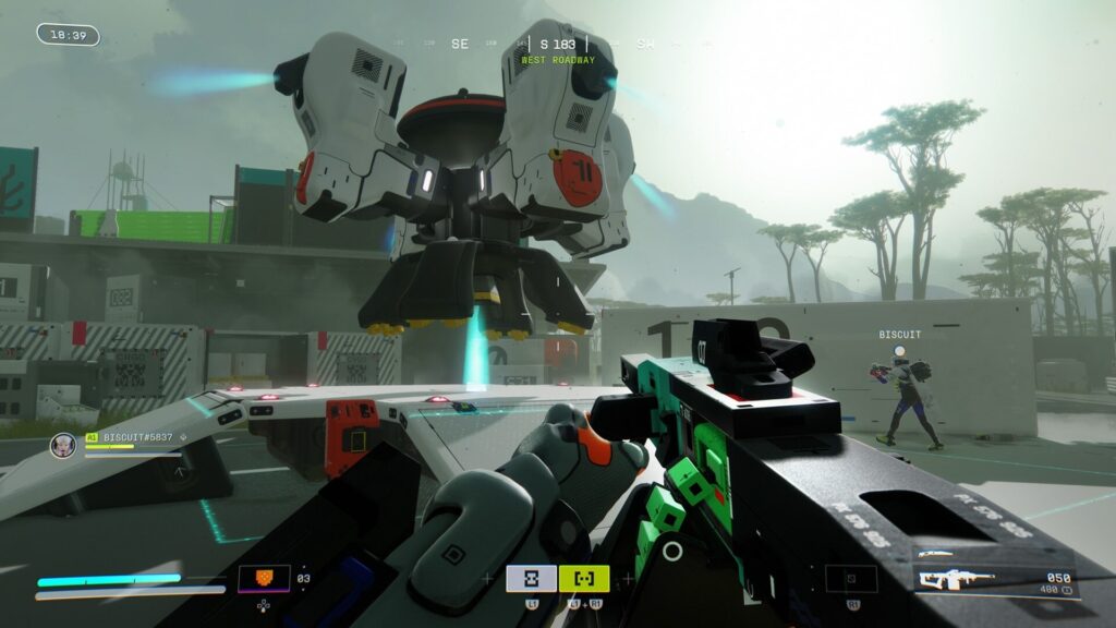 A player aiming a futuristic weapon towards a hovering drone in a foggy, sci-fi landscape with a teammate nearby.