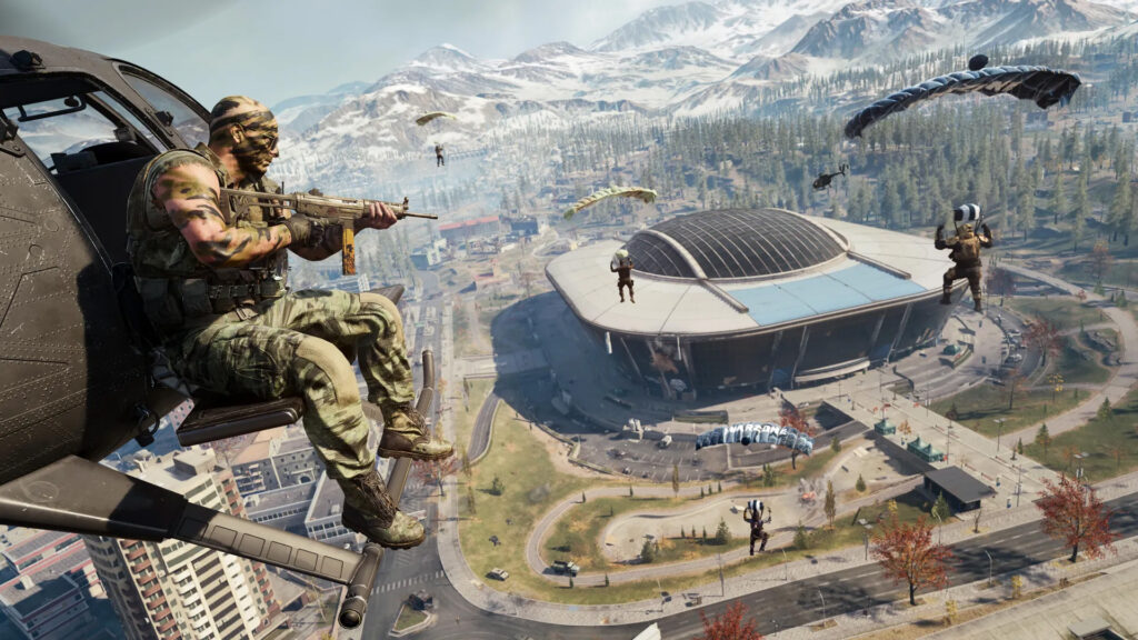 Imagem de Call of Duty: WarZone Players paraquedia para Verdansk. O Estádio Verdansk com o telhado fechado está em segundo plano
