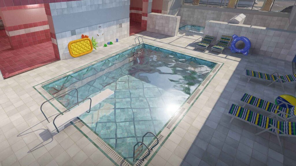 A colorful indoor pool area featuring a diving board, lounge chairs, a floating pineapple, and a playful beach ball.