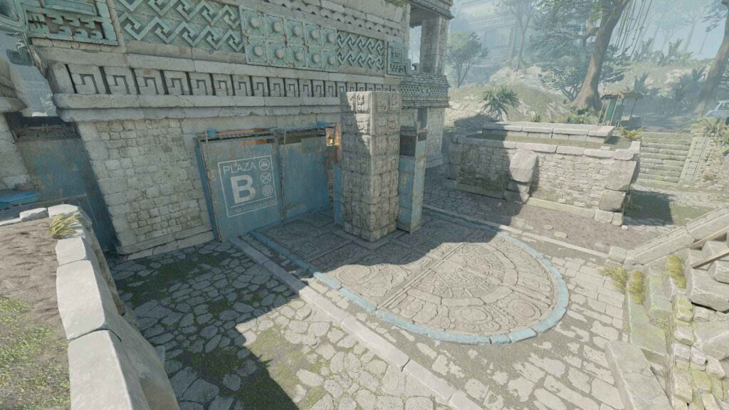 An ancient plaza with detailed stone carvings, a blue gate marked "Plaza B," and lush greenery in a misty environment.