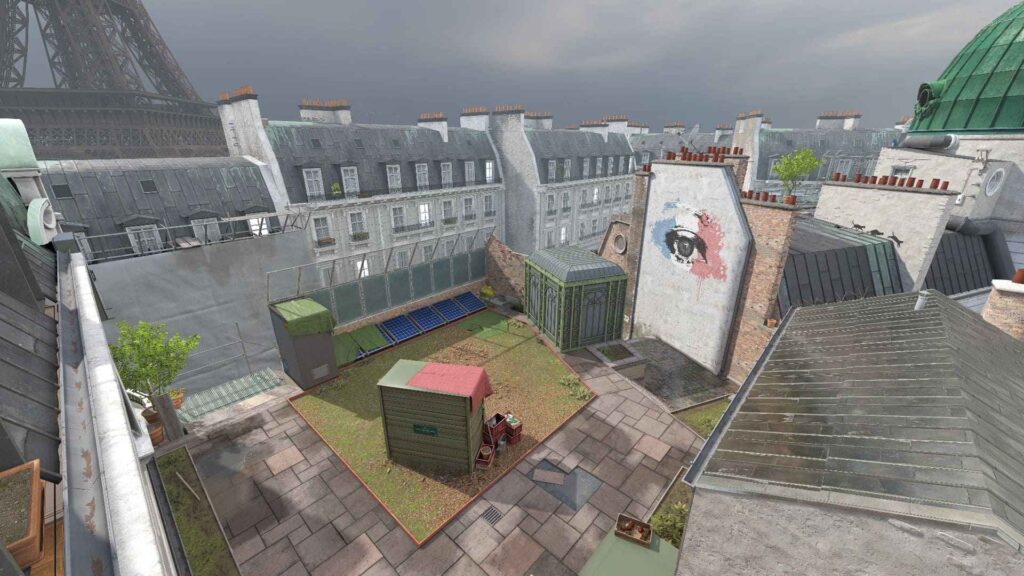 A rooftop view of Paris featuring eclectic buildings, a green shed, graffiti on a wall, and the Eiffel Tower in the background.