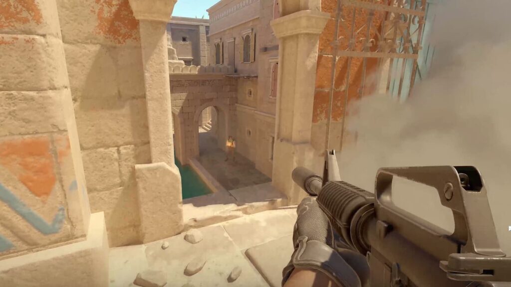 A player aiming a rifle from a rooftop, overlooking a stone pathway with a pool and smoke in CS2 game setting.