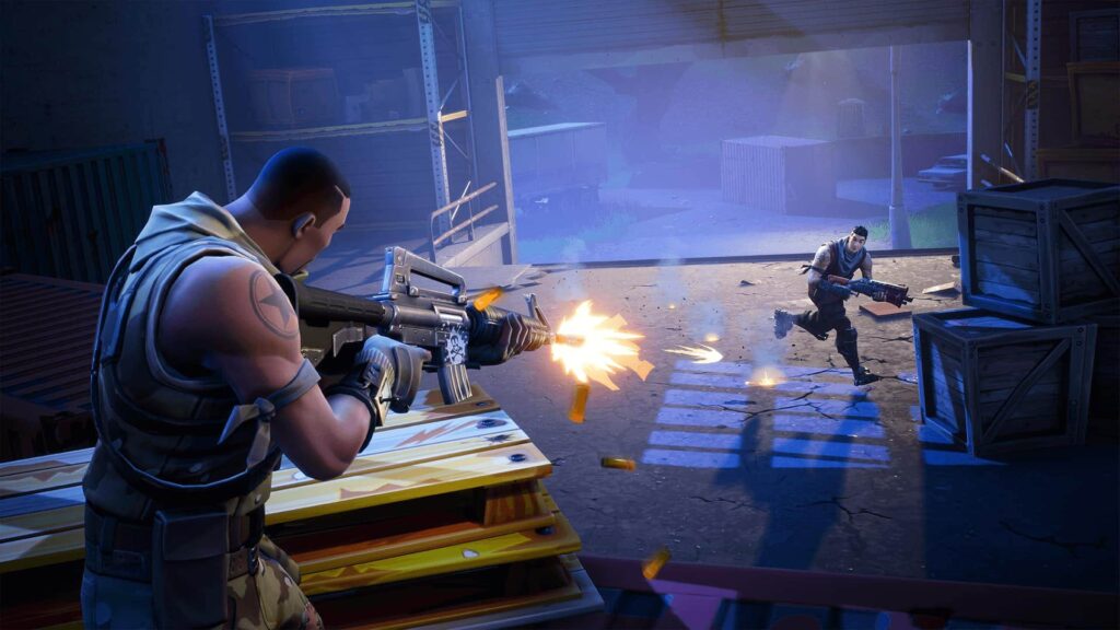 In-game screenshot from Fortnite showing two characters engaged in close-range gunfight inside a warehouse, with one firing an assault rifle and the other running with a shotgun.