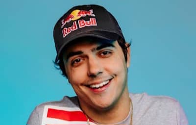 ImperialHal wearing a black Red Bull cap and a gray shirt with a red stripe, set against a light blue background.