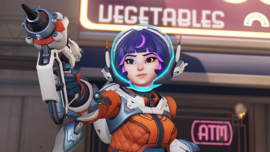 Juno from Overwatch 2 in a futuristic space suit aiming her weapon, standing in front of a neon “Vegetables” sign