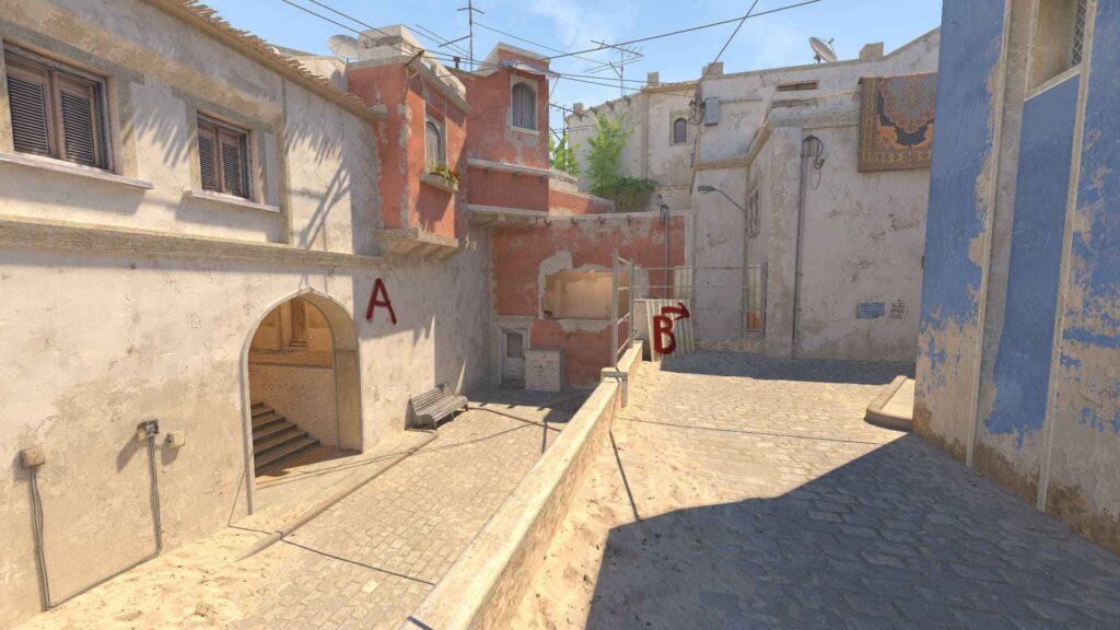 A sunlit narrow street scene with weathered buildings, marked "A" and "B," showcasing cobblestone pavement and antennas above.