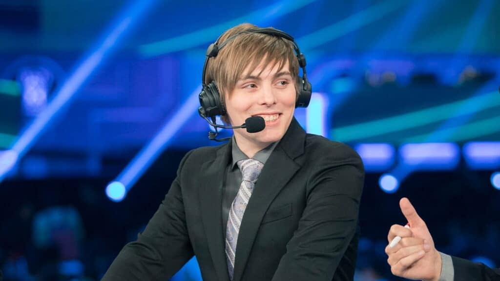 Nick De Cesare wearing a headset and suit