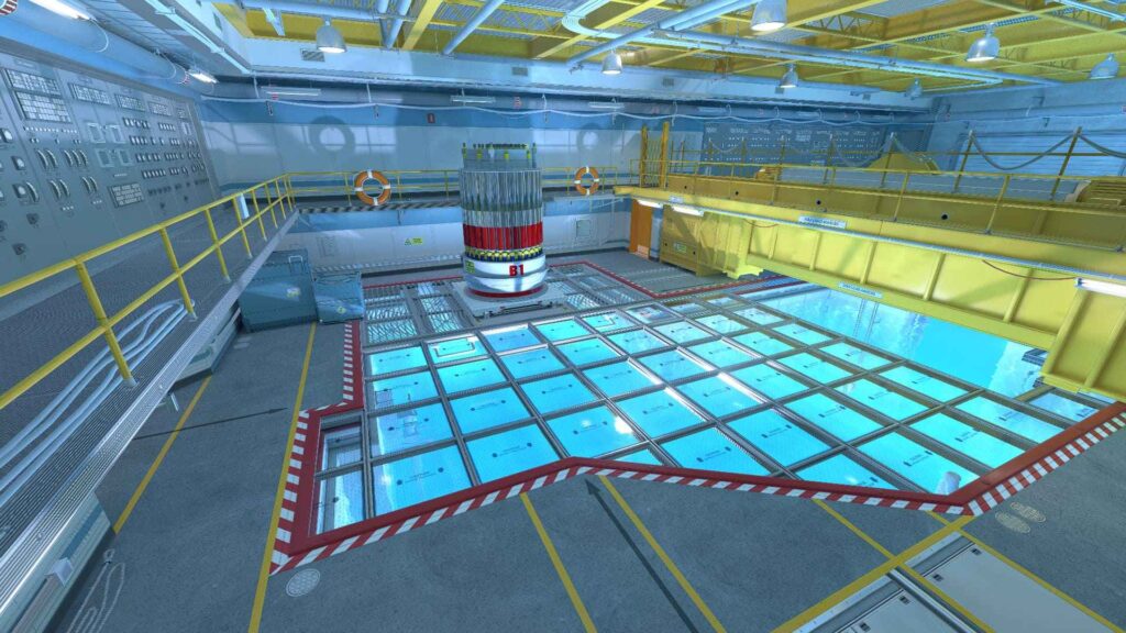 An indoor facility with a clear, blue water pool and a cylindrical reactor at the center, surrounded by control panels and safety equipment.