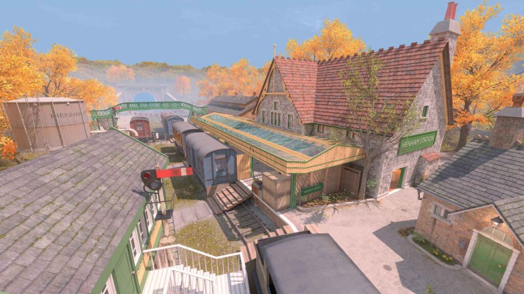 A charming train station surrounded by autumn trees, featuring vintage trains and classic architecture in a serene setting.