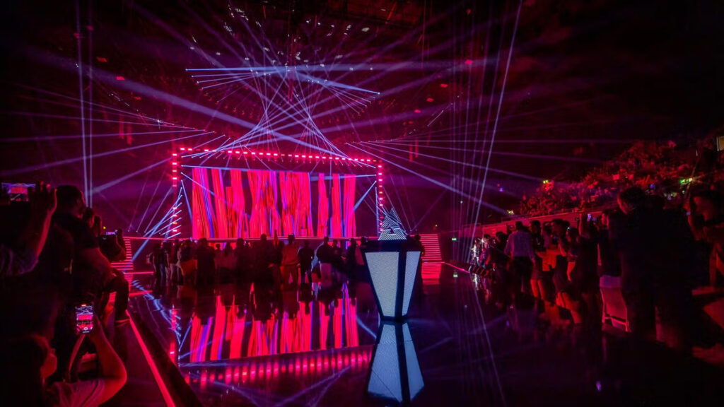 Image of BLAST esports tournament trophy on a stage lit with red and blue lighting