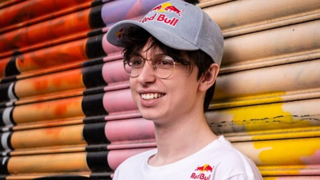 Image of Caedrel wearing Red Bull merchandise on a multicoloured background