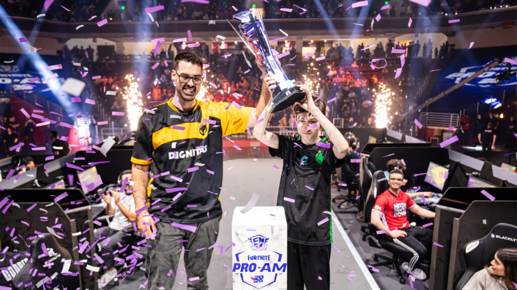 Image of AussieAntics and Peterbot holding FNCS Pro-Am trophy on stage surrounded by confetti