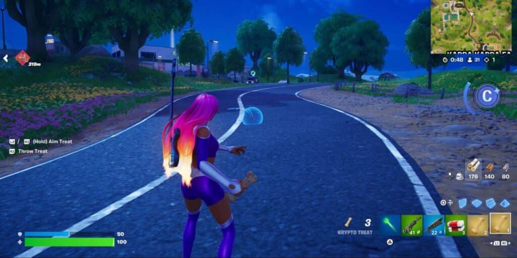 Fortnite character holding a Krypto Treat and aiming its throw on a curved road at night, with throw trajectory indicator visible on screen