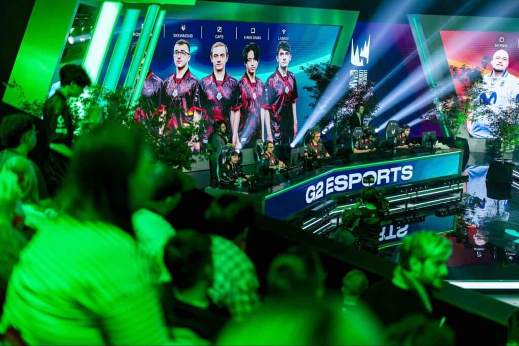 G2 Esports on stage during a LoL match with player portraits onscreen