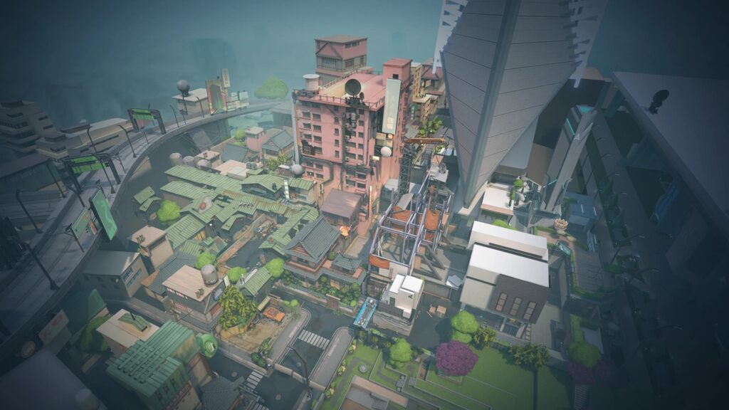Aerial view of a vibrant cityscape of a Split map of VALORANT featuring a mix of modern and traditional buildings, separated by a winding road amidst greenery.