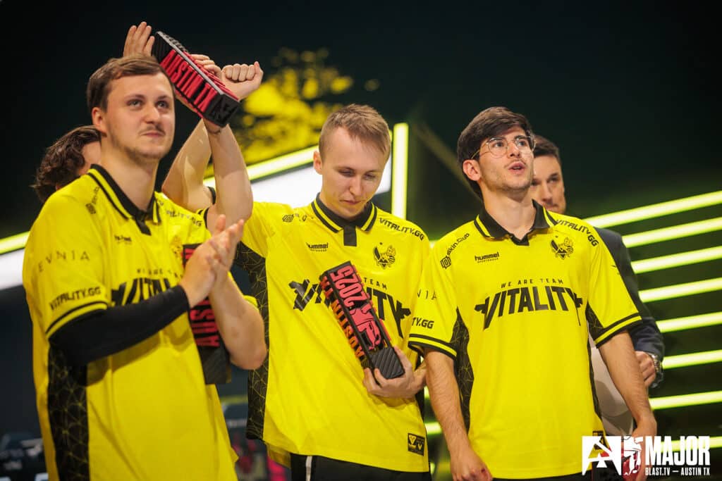 Image of Team Vitality Counter Strike players holding small trophies on stage at BLAST Austin Major