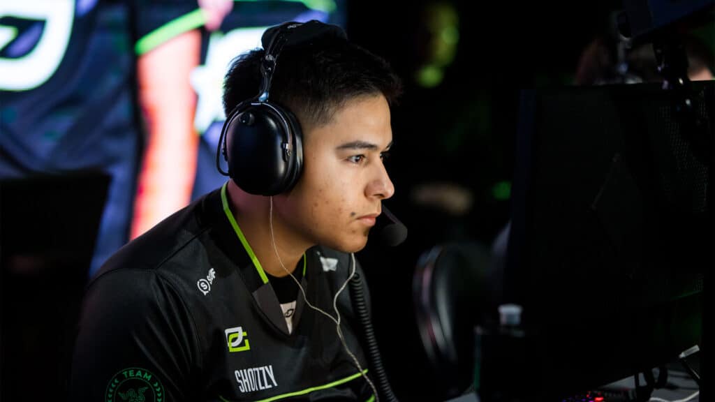 OpTic Texas Shotzzy competing at Call of Duty League event. The player is wearing a headset while looking at a monitor.