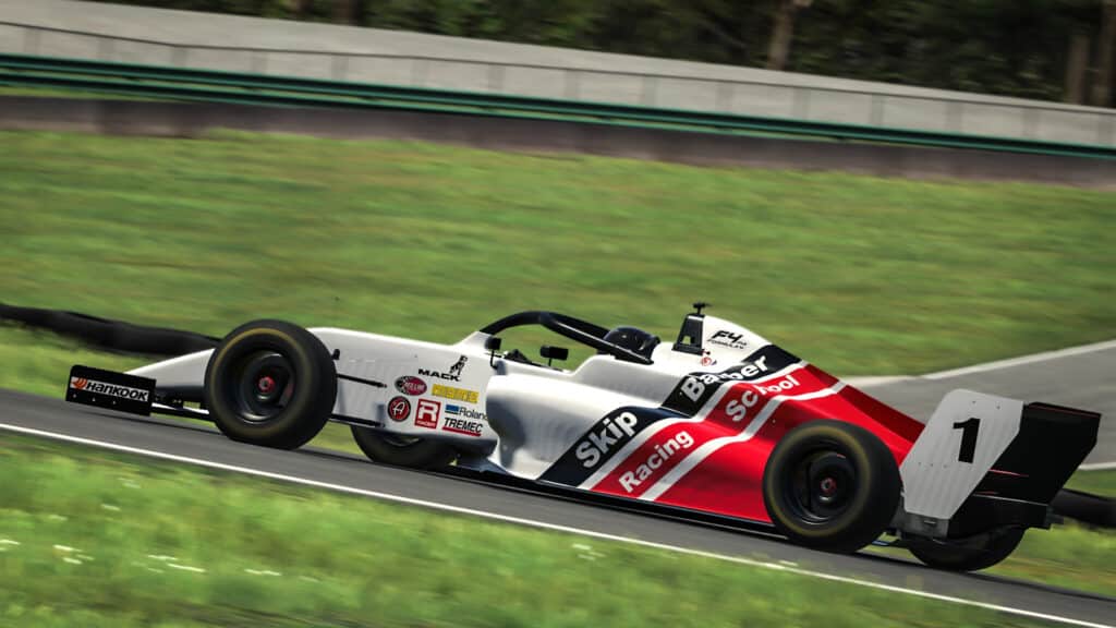 Image of iRacing F4 car with a red and white Skip Barber livery driving on virtual race track.