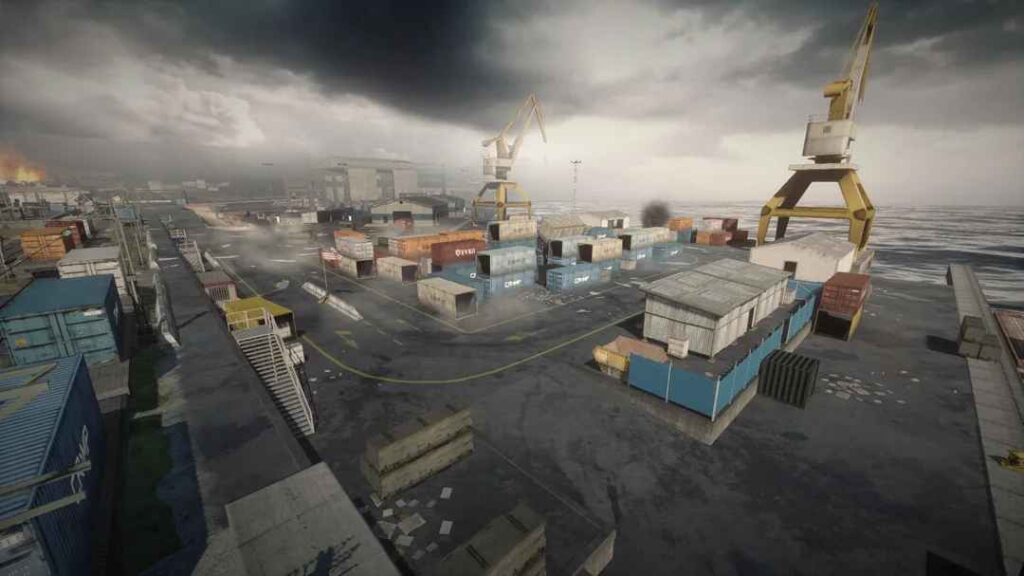 A gloomy industrial port scene with stacked shipping containers, cranes, and an overcast sky, hinting at chaos in the background.