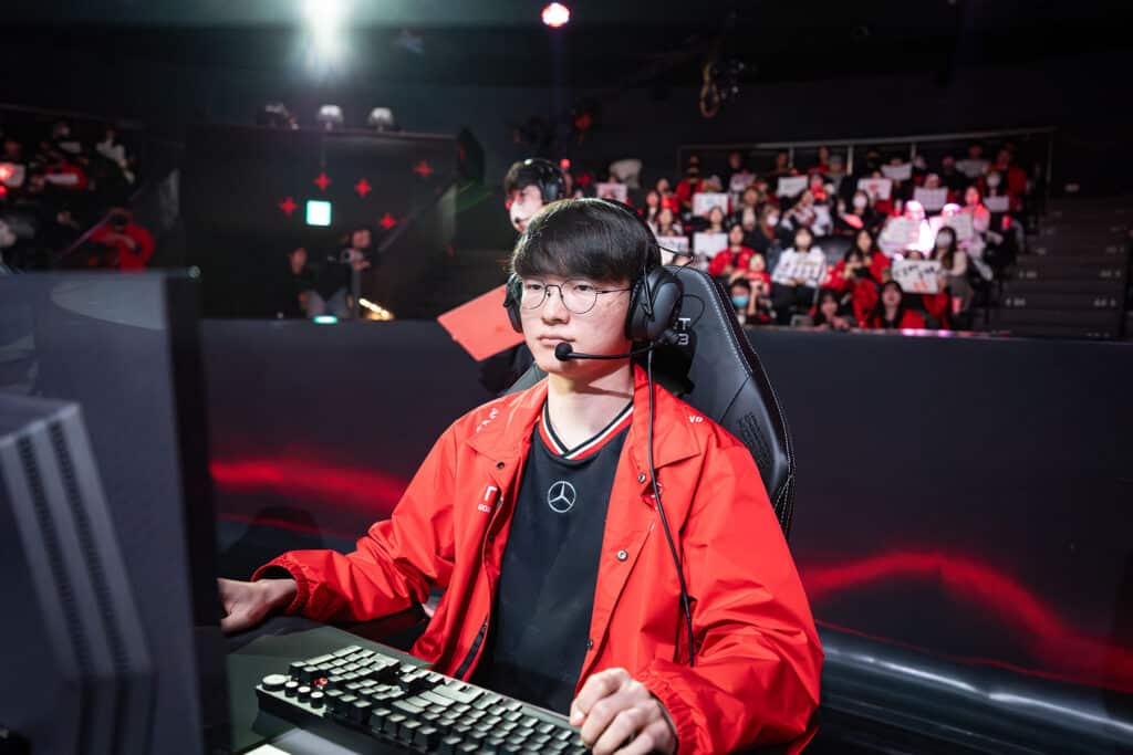 Image of Faker competing at League of Legends tournament with a crowd of fans in the background
