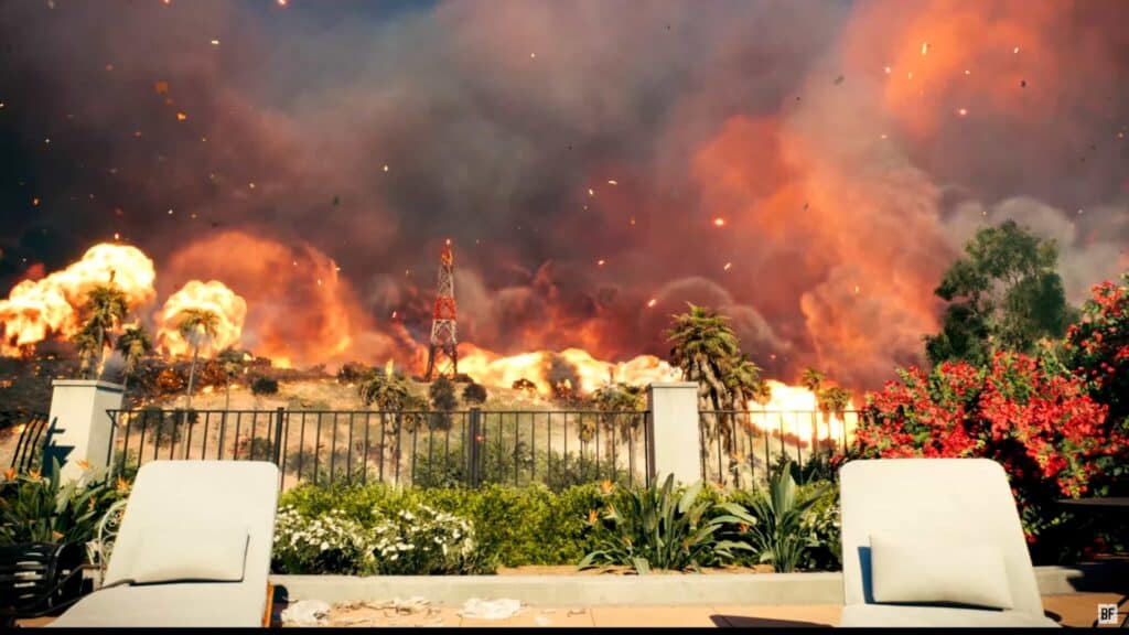 Massive wildfire with intense flames and thick smoke near palm trees and communication tower