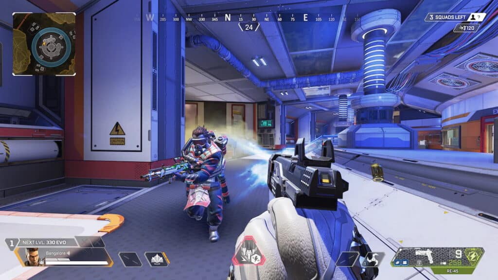 First-person view of Apex Legends game, character aiming at an armored enemy in a high-tech corridor