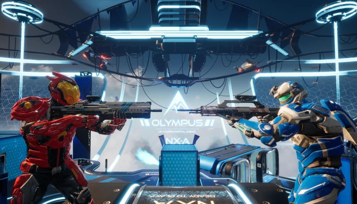 Two futuristic armored figures in red and blue suits aim weapons at each other in a high-tech arena