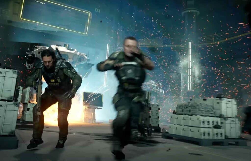 Two soldiers in high-tech gear run frantically in a futuristic industrial setting, with explosions and debris in the background, conveying urgency and action.