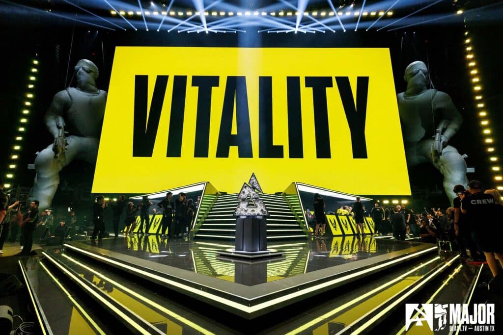 Team Vitality name projected onto large screen above BLAST Austin Major stage, with the trophy in the center.