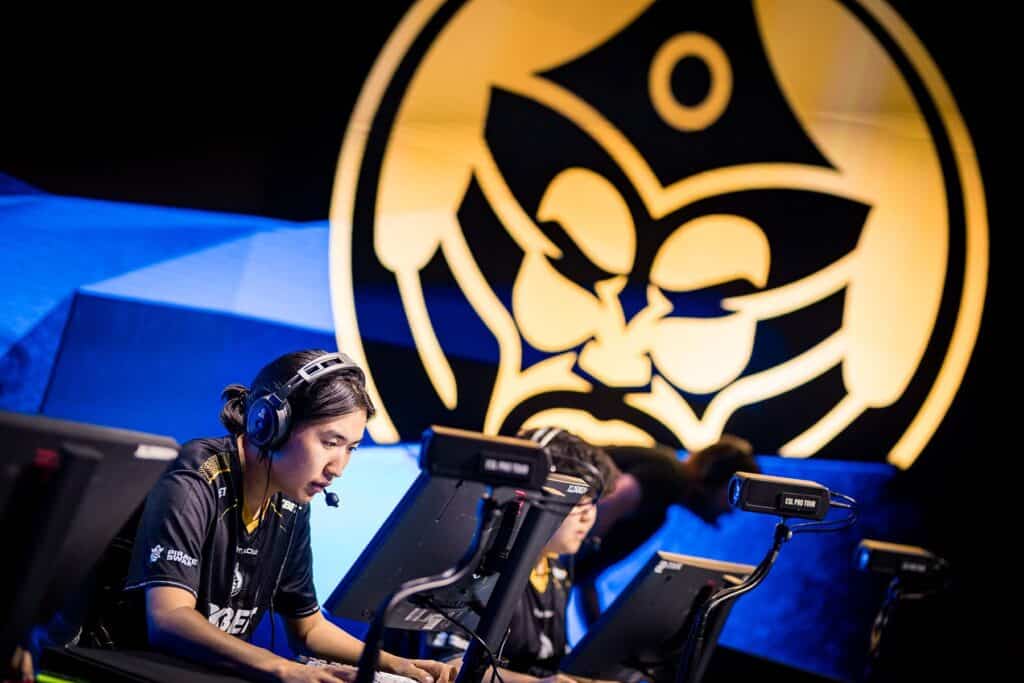 Image of The MongolZ Counter-Strike player competing on stage with The MongolZ logo projected onto a screen in the background