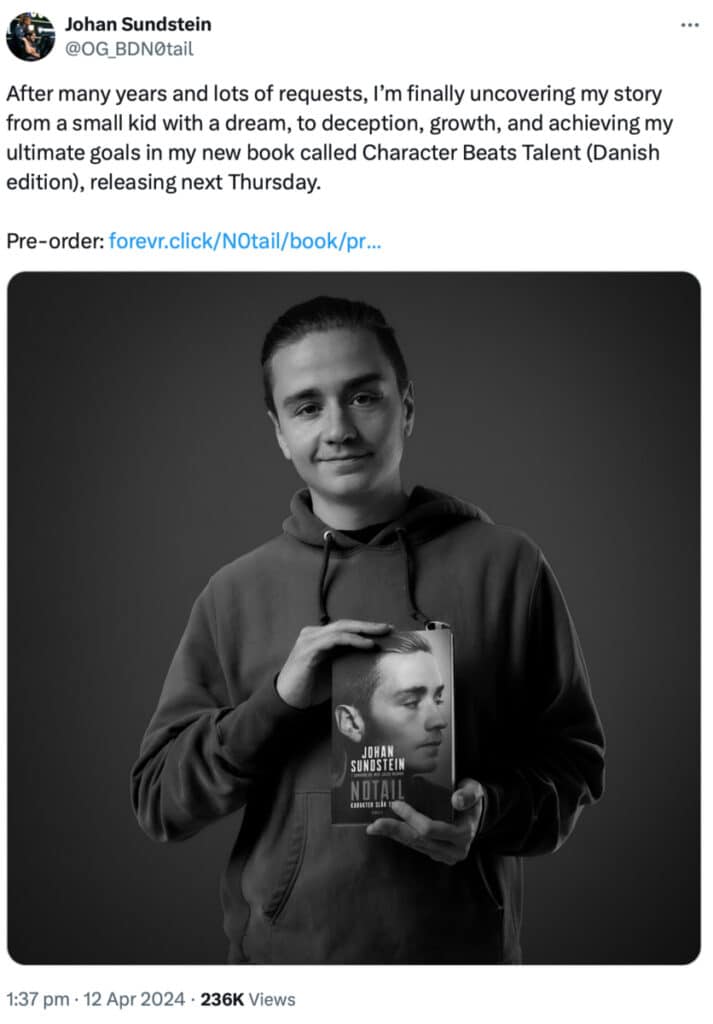 L'uomo che tiene un libro con il suo ritratto in copertina.