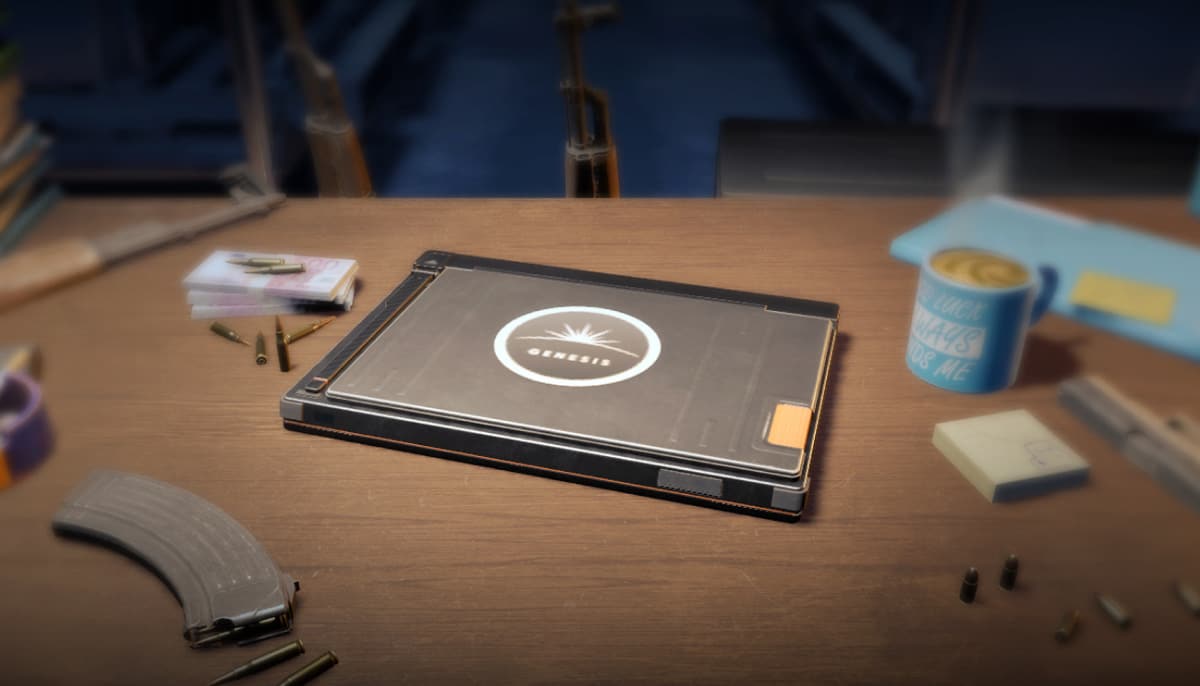 A closed laptop labeled "Genesis" sits on a wooden desk, surrounded by papers, bullets, a magazine, and a blue mug