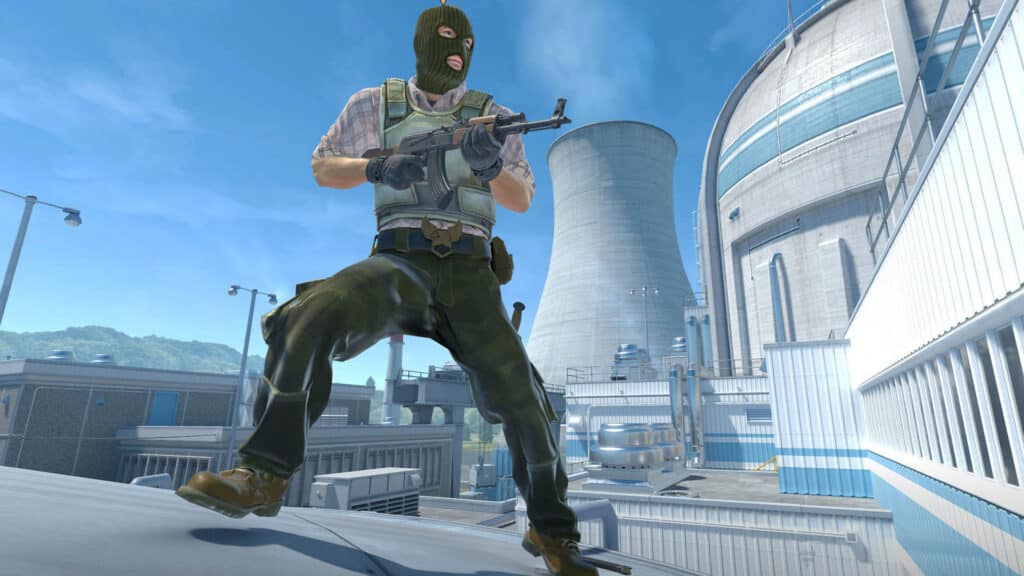 Image of Counter-Strike player holding an AK-47 while standing on top of a silo on the Nuke map