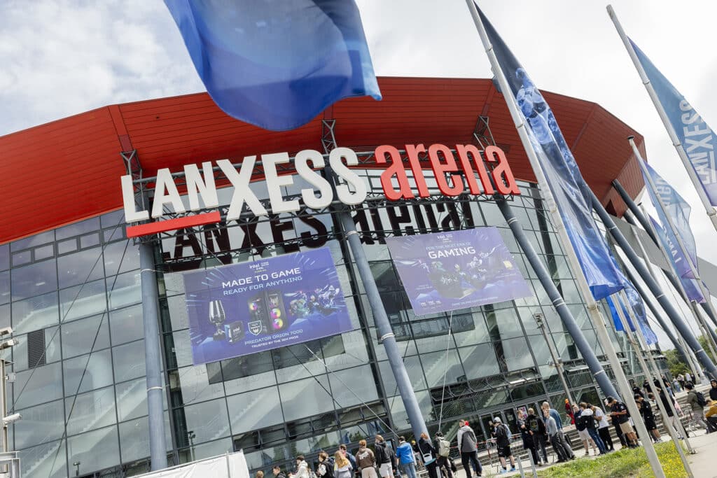 Image of the Lanxess Arena in Cologne, Germany. Flags and advertising are surrounding the outside of the building