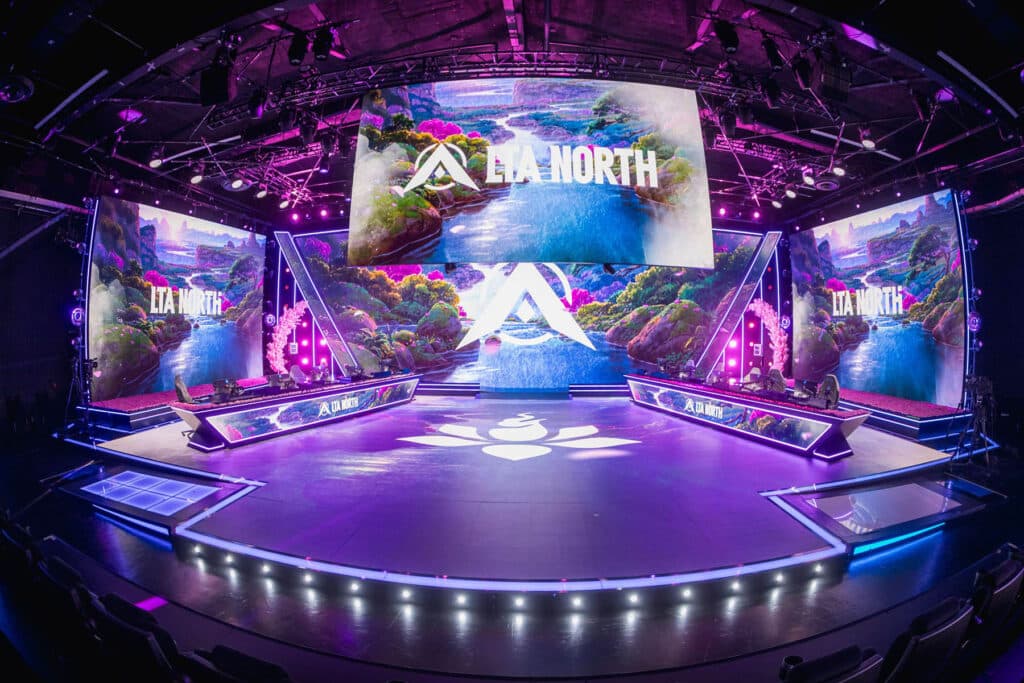 Image of League of Legends LTA North Stage illuminated by pink and purple lighting. The LTA North logo is being displayed on screens