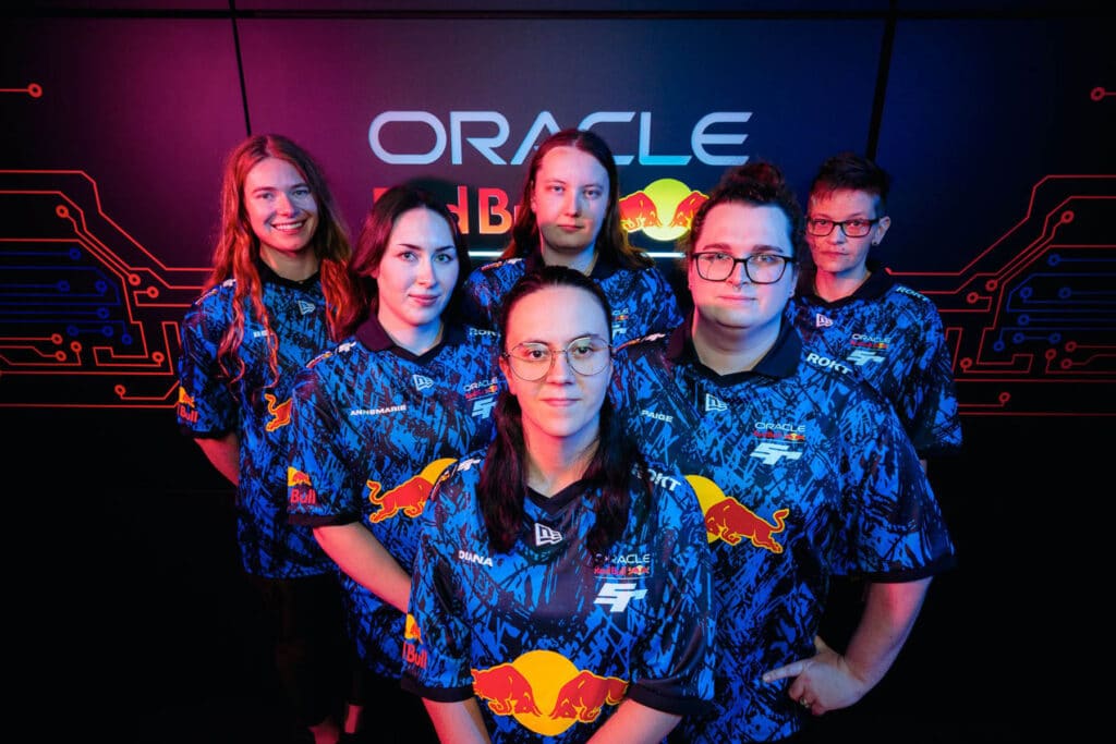 Image of Red Bull Racing female sim racing team standing in front of Oracle Red Bull Racing logo