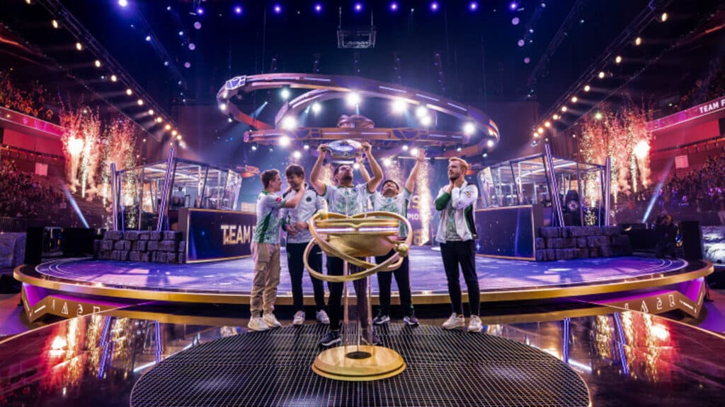 Team Falcons players celebrate on stage after winning The International 2025 trophy.