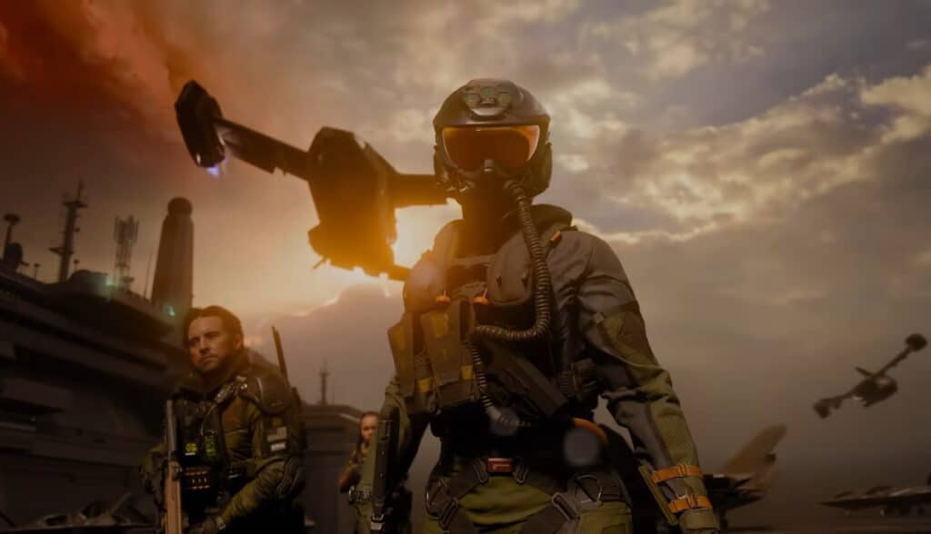 A soldier in futuristic armor and helmet stands on an aircraft carrier deck at sunset, with drones flying overhead in Black Ops 7