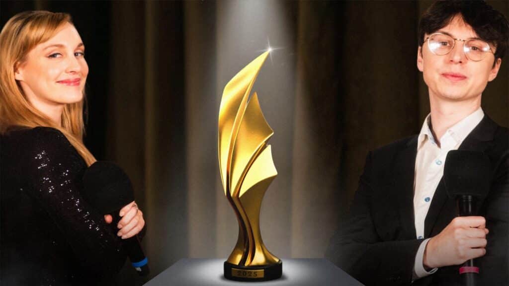 Image of Sjokz and Caedrel standing either side of a golden trophy on a small platform. Caedrel is holding a microphone