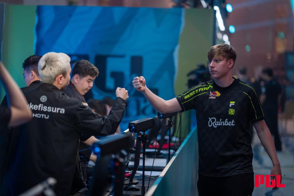 Image of Ninjas in Pyjamas Counter-Strike player fist-bumping an opponent at PGL Astana 2025