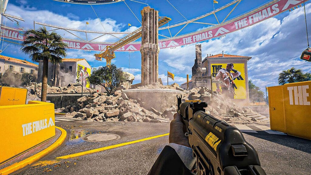 Image of The Finals player holding an assault rifle with yellow structures in the background