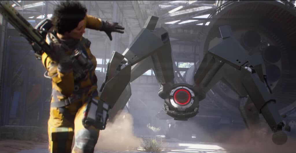 A person in futuristic armor dodges a large, four-legged robotic creature with a glowing red eye in an industrial setting in Arc Raiders