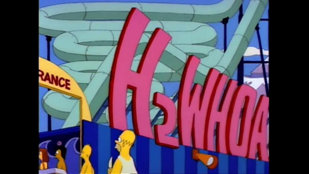 L'immagine è tratta dalla serie animata “I Simpson” e mostra l'ingresso di un parco acquatico chiamato H₂WHOA!