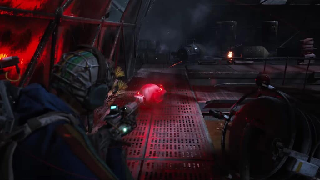 A person in futuristic armor aims a weapon in a dimly lit, industrial sci-fi setting in Arc Raiders