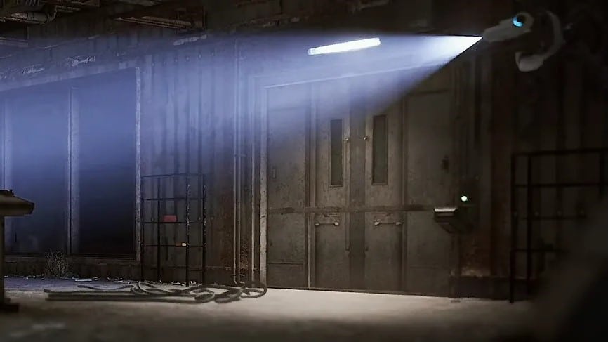 Dimly lit industrial corridor with a spotlight from a security camera illuminating a double metal door in Arc Raiders